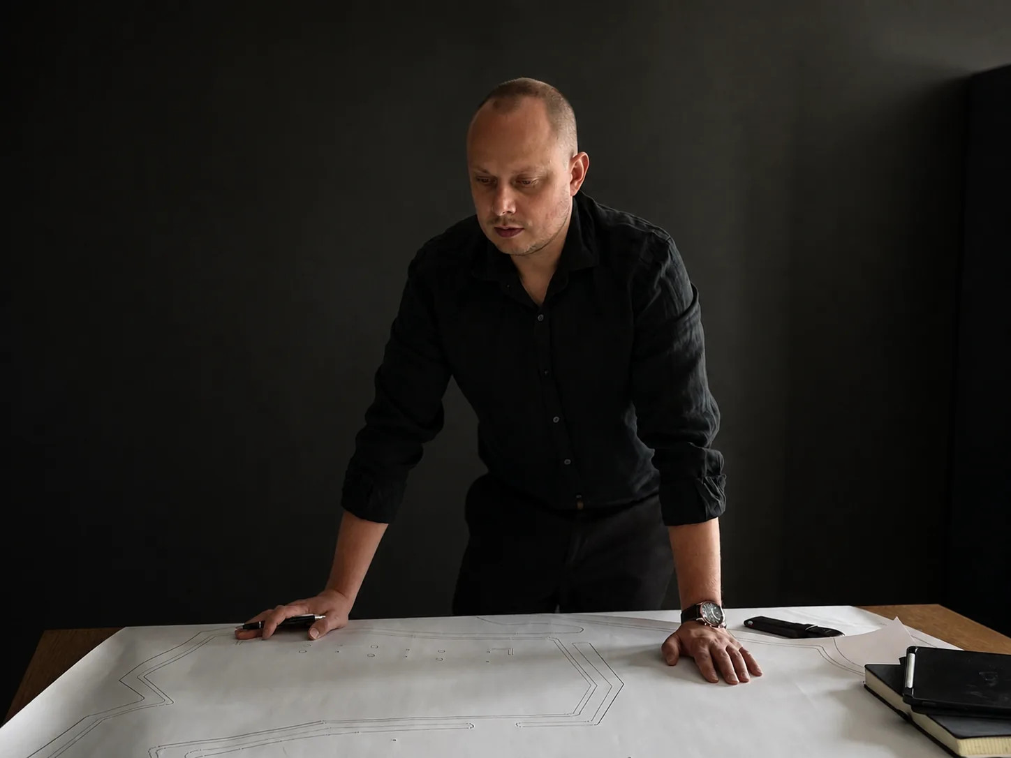 Radosław Nicgorski working with maps and drawings